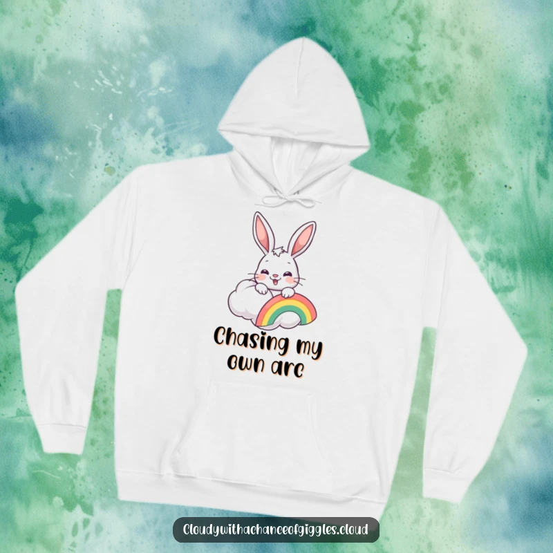 Funny bunny peeking from a cloud, holding a rainbow, on a cozy hoodie, perfect for cold days.