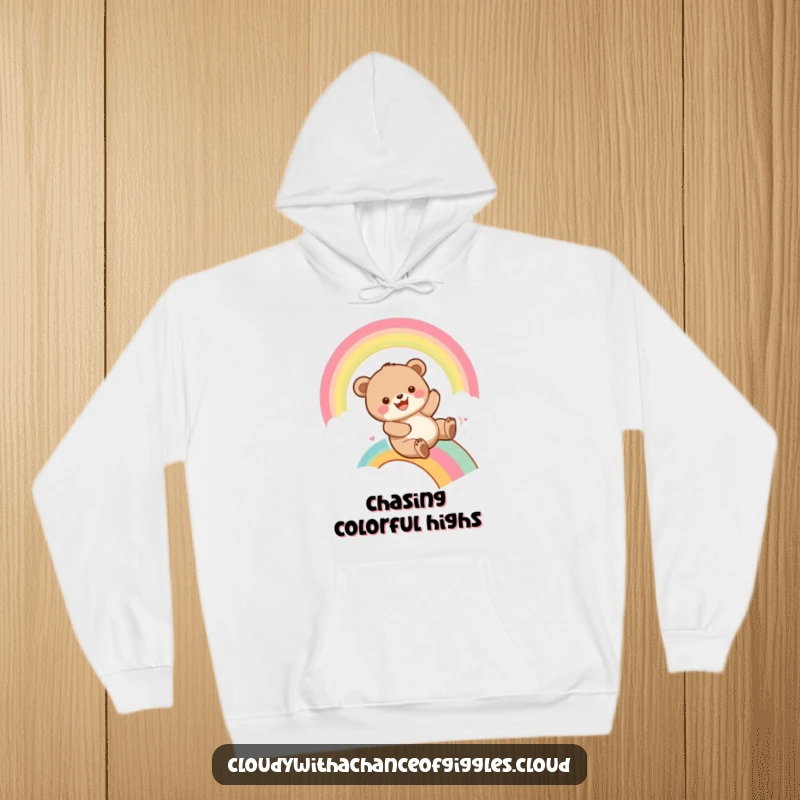 Funny bear cub sliding down a bright rainbow with a wide grin, printed on a warm hoodie, offering comfort and playful humor.