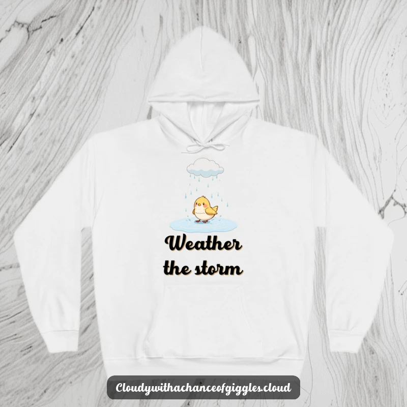 Funny bird hoodie, a small bird splashing with delight in a puddle with a cute rain cloud overhead, cozy and cheerful.