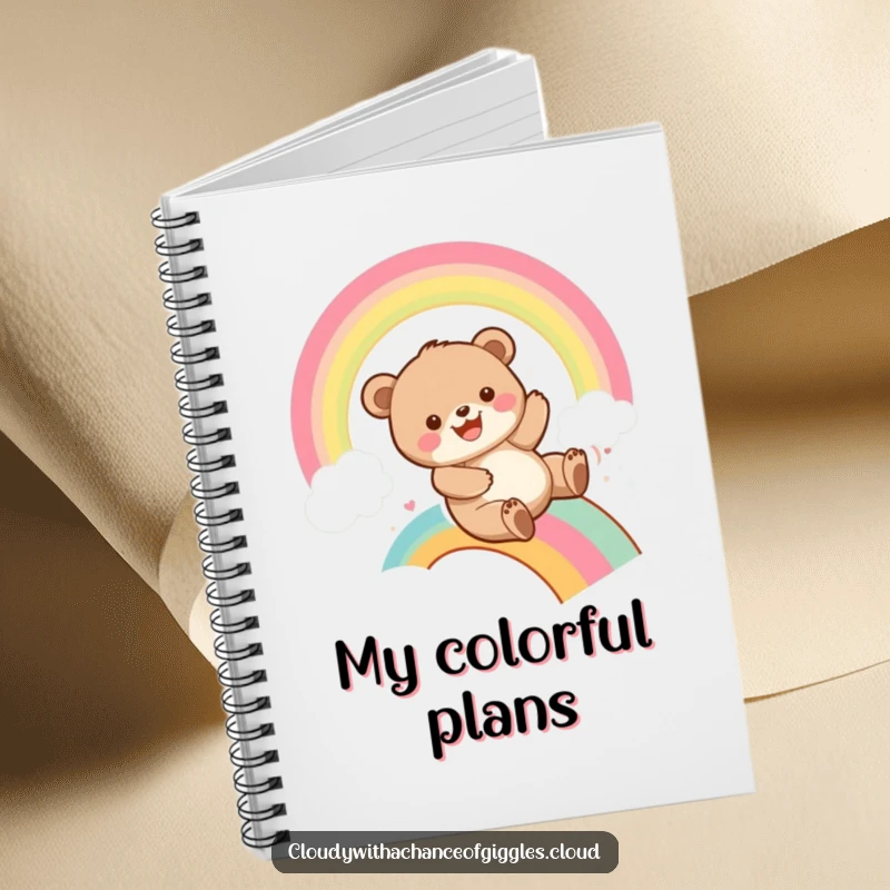 Funny bear cub sliding down a colorful rainbow with a grin, adorning a notebook cover, inspiring creativity and playful note-taking.